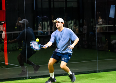 man with hat and padel